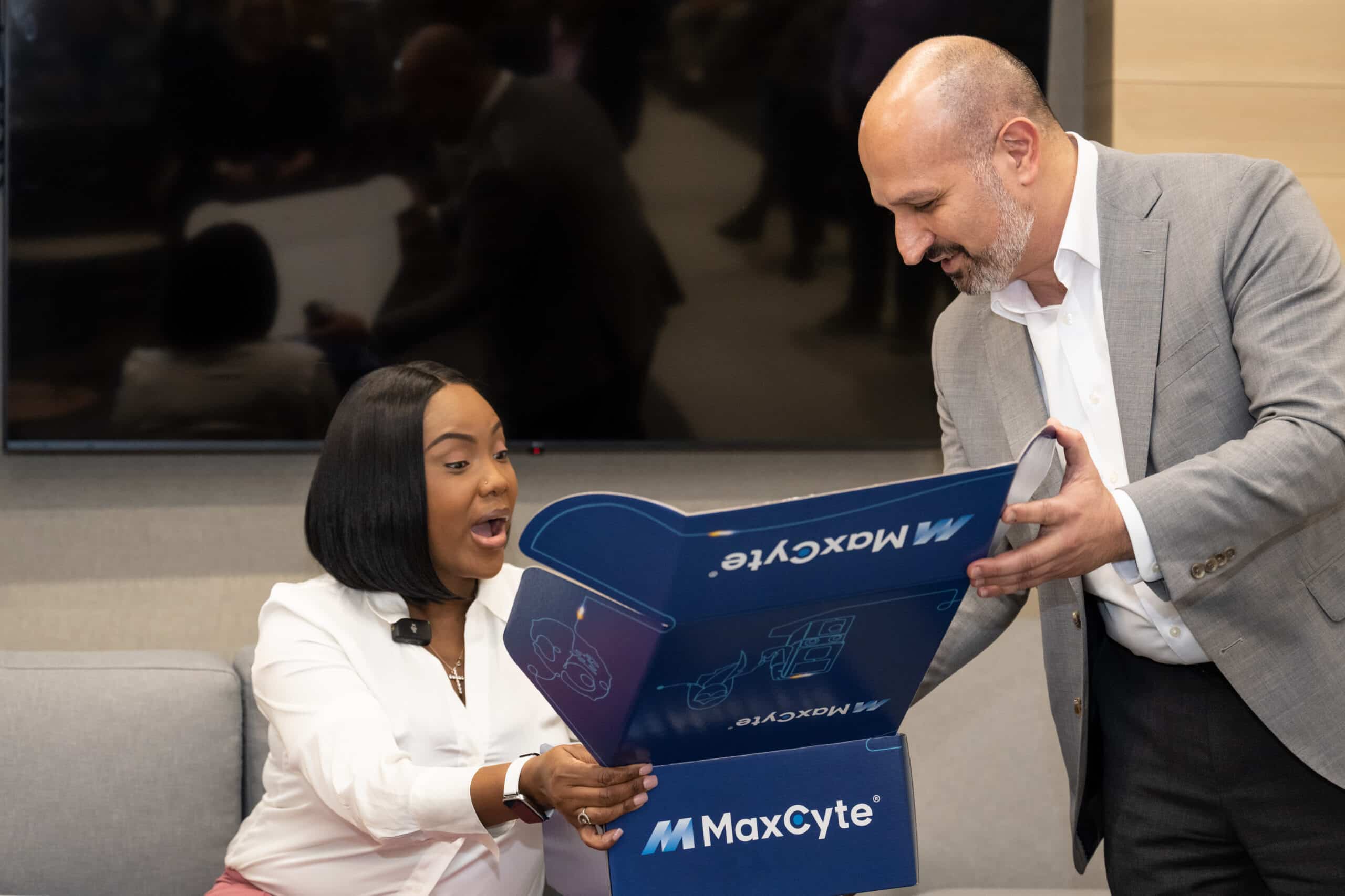 Victoria Gray being presented with a gift box from MaxCyte by Maher Masoud, CEO of MaxCyte